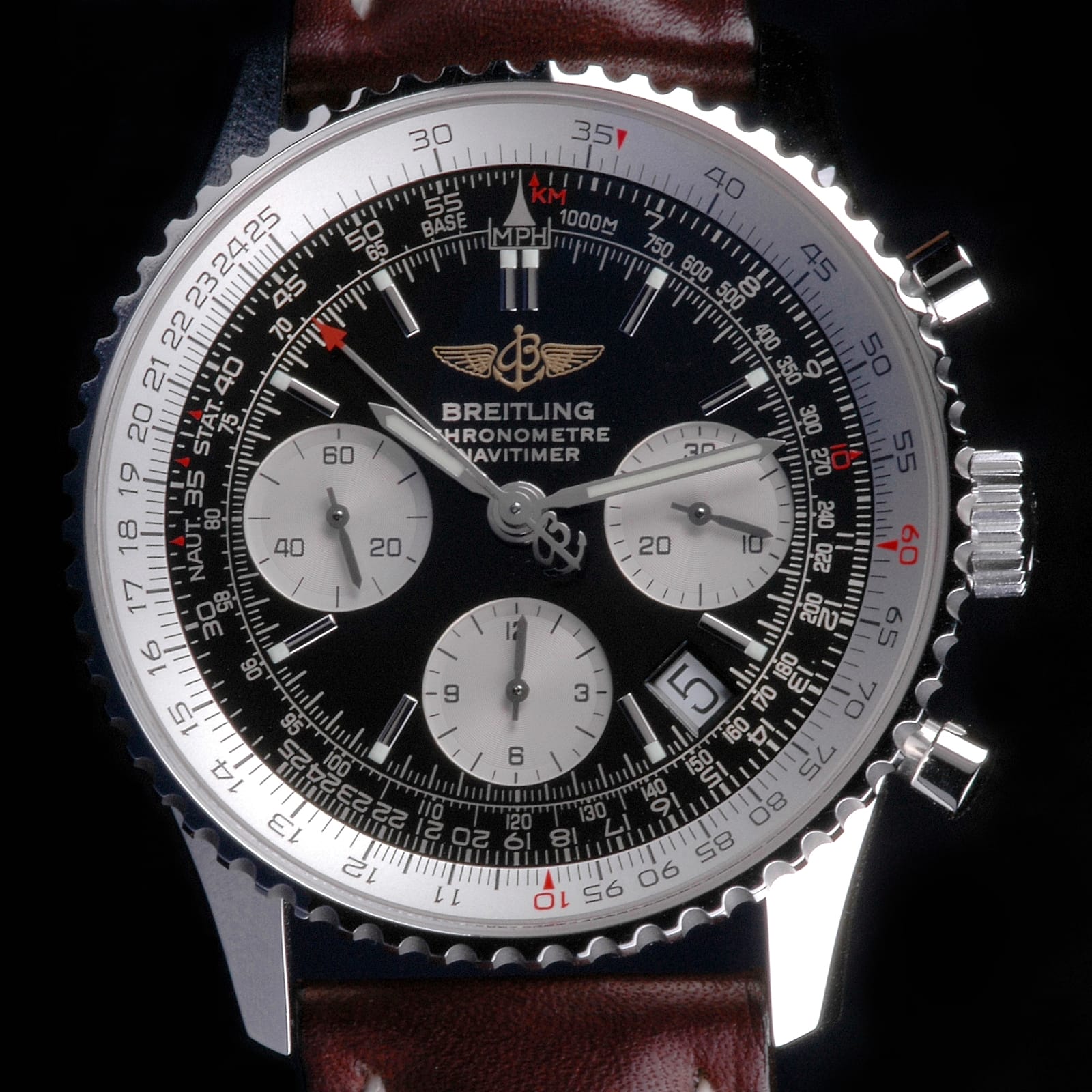 Breitling Navitimer chronograph with black dial and slide-rule bezel on a brown leather strap