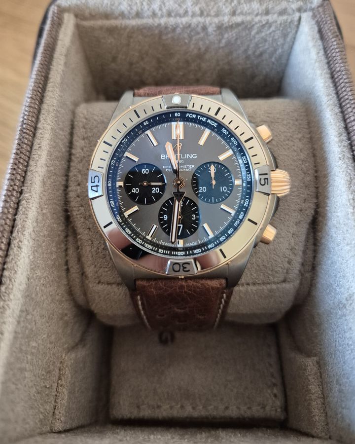 Breitling Chronomat chronograph with grey dial and brown leather strap in its watch box