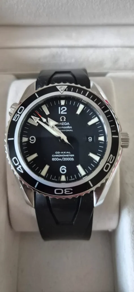 Omega Seamaster Planet Ocean with black dial and rubber strap in its box