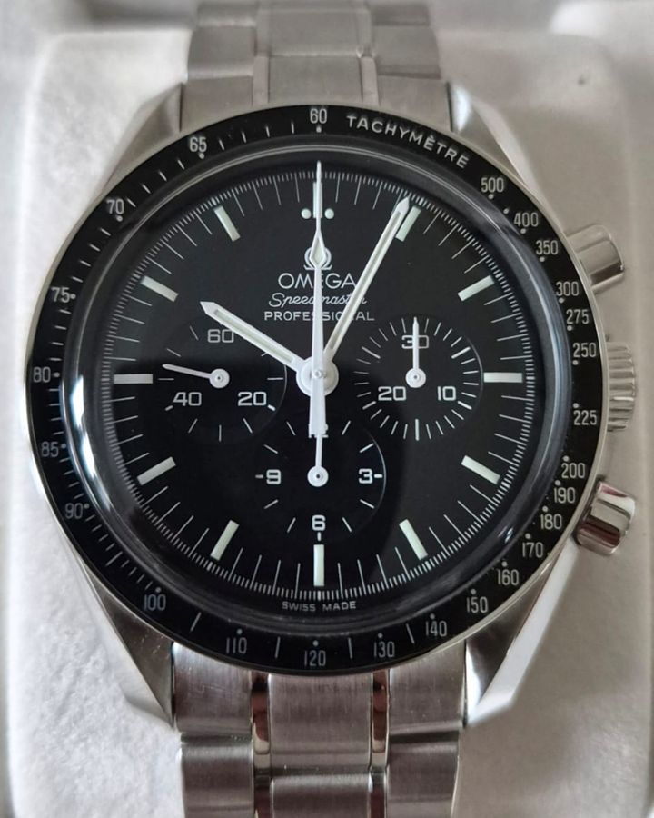 Omega Speedmaster Professional chronograph with black dial and tachymeter bezel on a steel bracelet