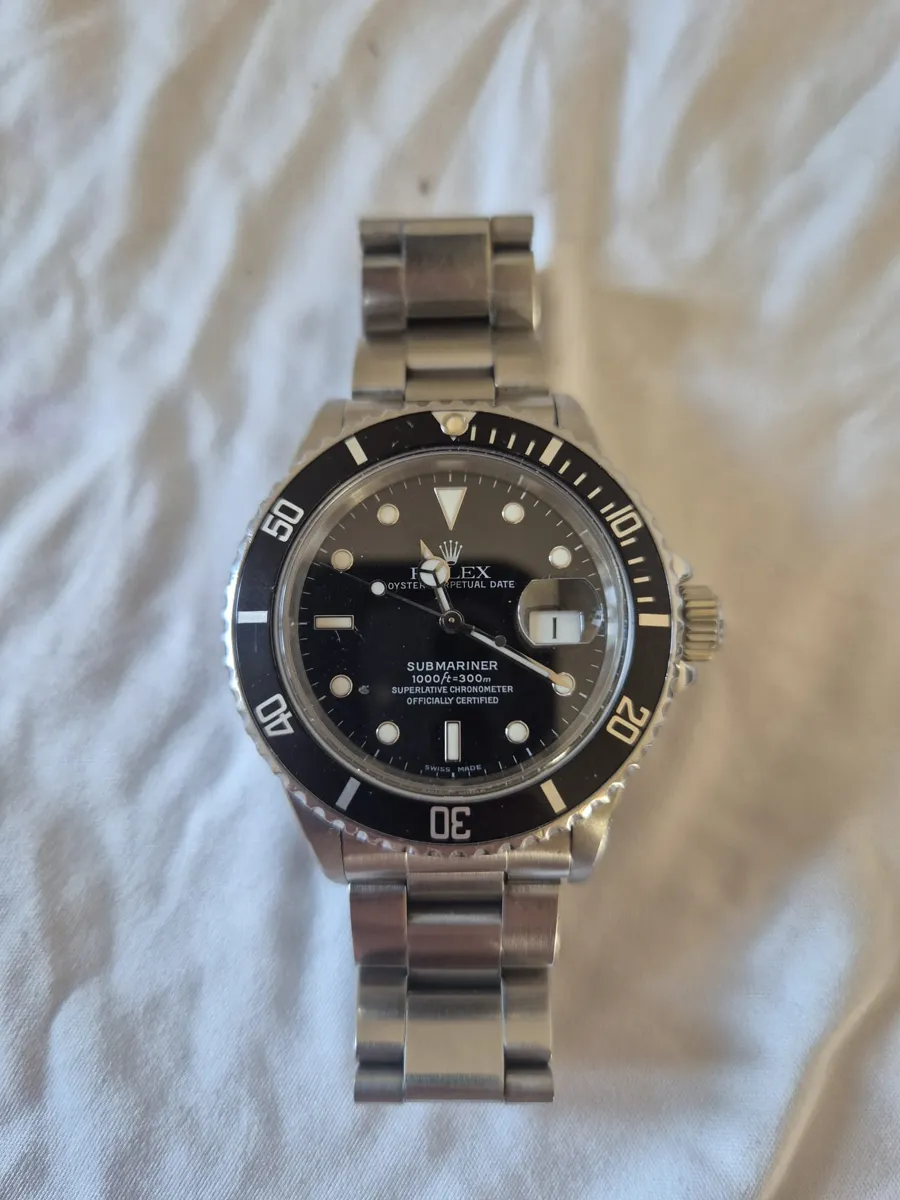 Steel Rolex Submariner Date with black dial, black bezel and Oyster bracelet